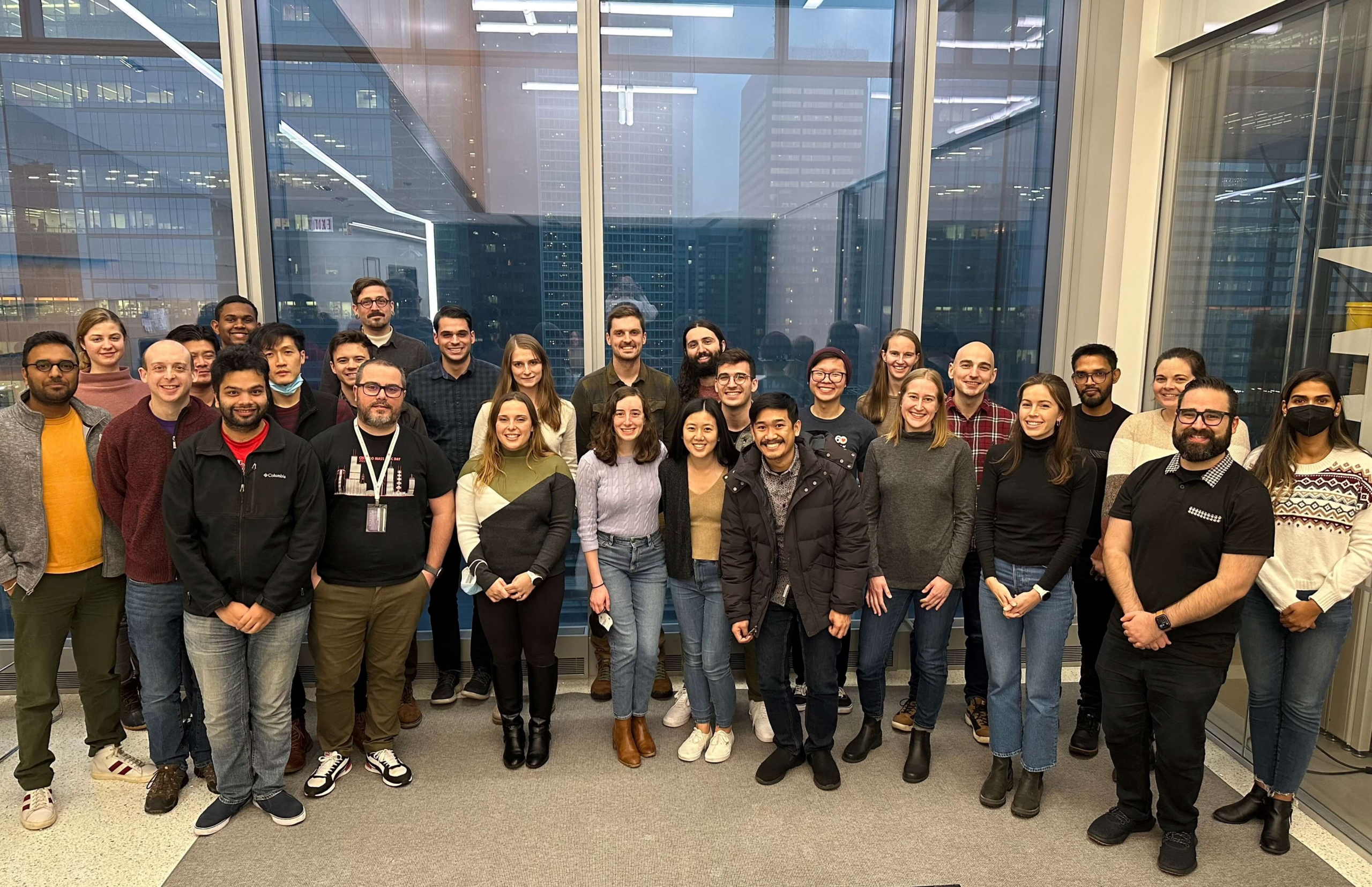 CSB Group posing in front of SQBRC Collaboration Space windows