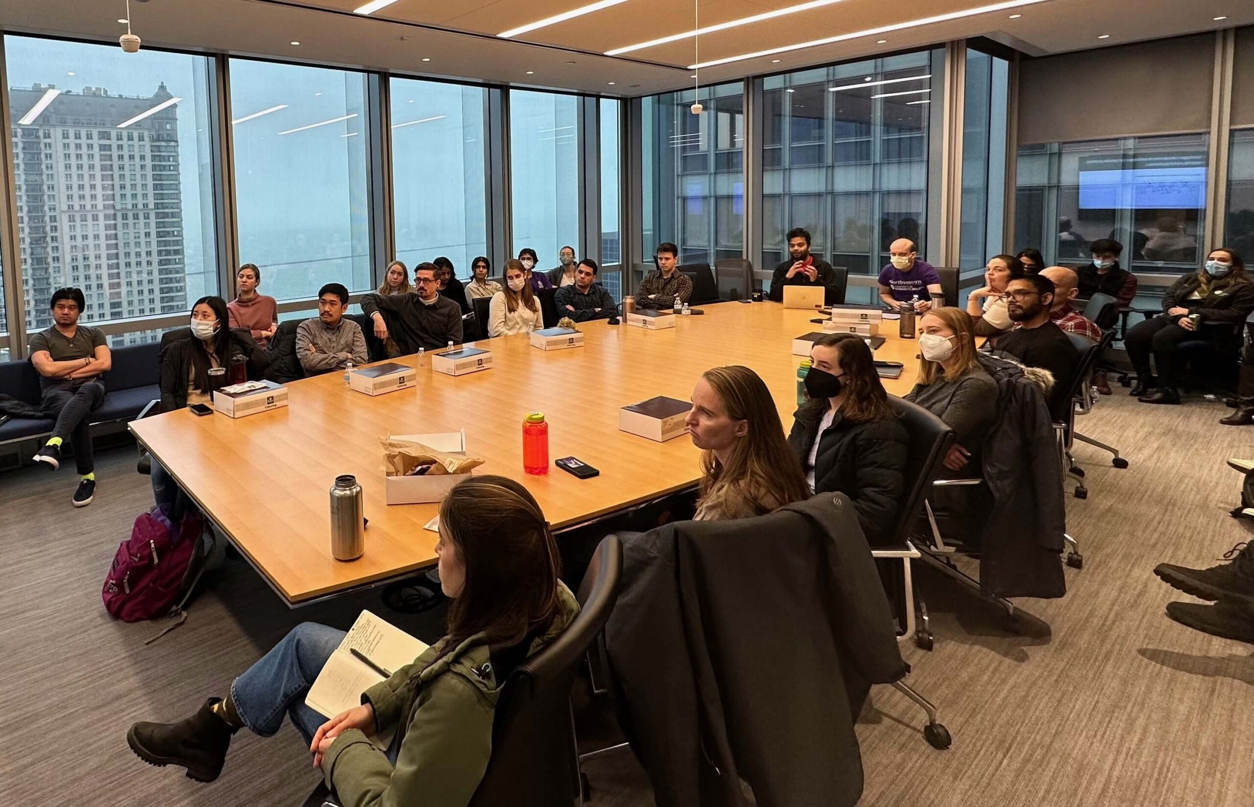 CSB research day in conference room, students and faculty at table